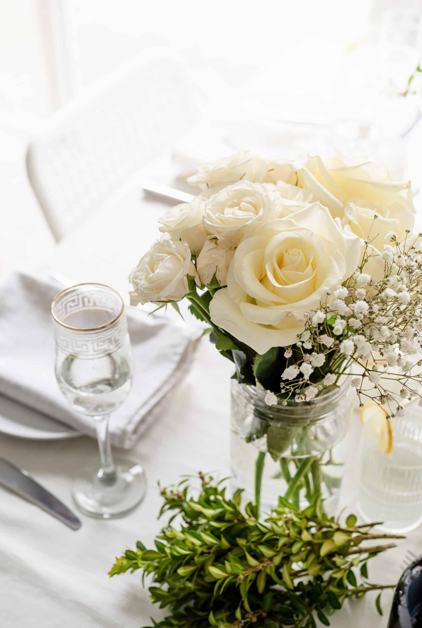 The wedding decor. Wedding teble decoration with white roses, closeup